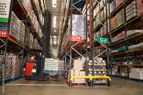 Lowering stock in a distribution warehouse using aisle truck