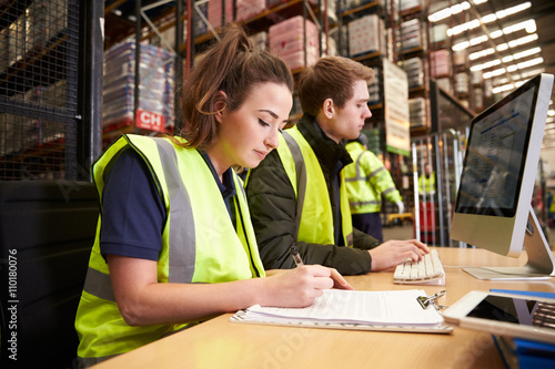 Staff managing warehouse logistics in an on-site office photo