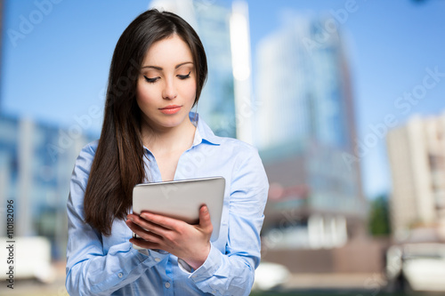 Woman using a digital tablet outdoor