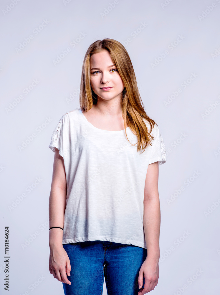 Girl in jeans and t-shirt, young woman, studio shot Girl in jeans and t-shirt, young woman, studio shot