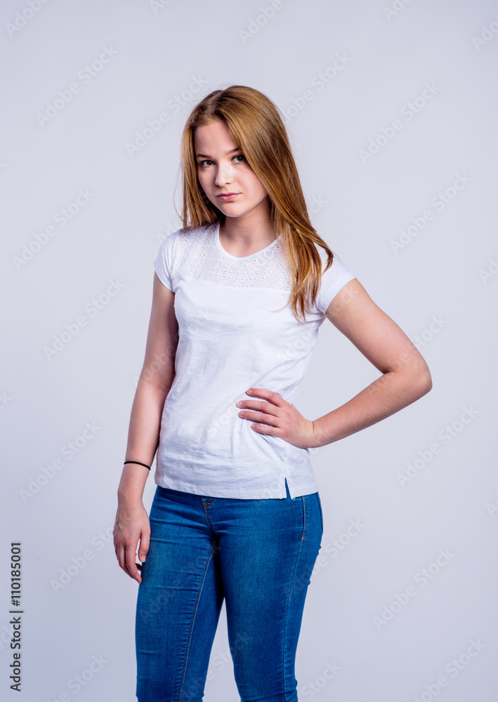 Girl in jeans and t-shirt, young woman, studio shot Girl in jeans and t-shirt, young woman, studio shot