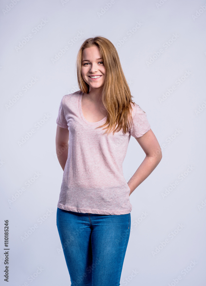 Girl in jeans and t-shirt, young woman, studio shot Girl in jeans and t-shirt, young woman, studio shot
