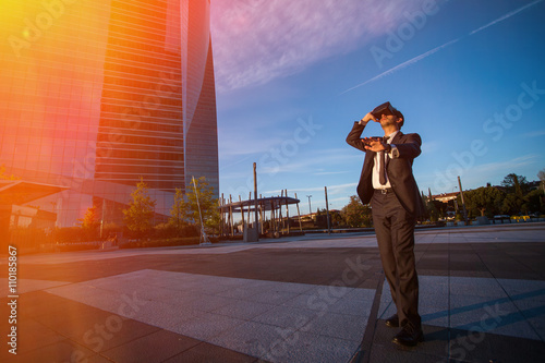 Businessman wearing virtual reality glasses and doing gestures with his hands outdoors. Modern business concept