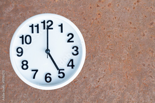 Clock on steel rusty background