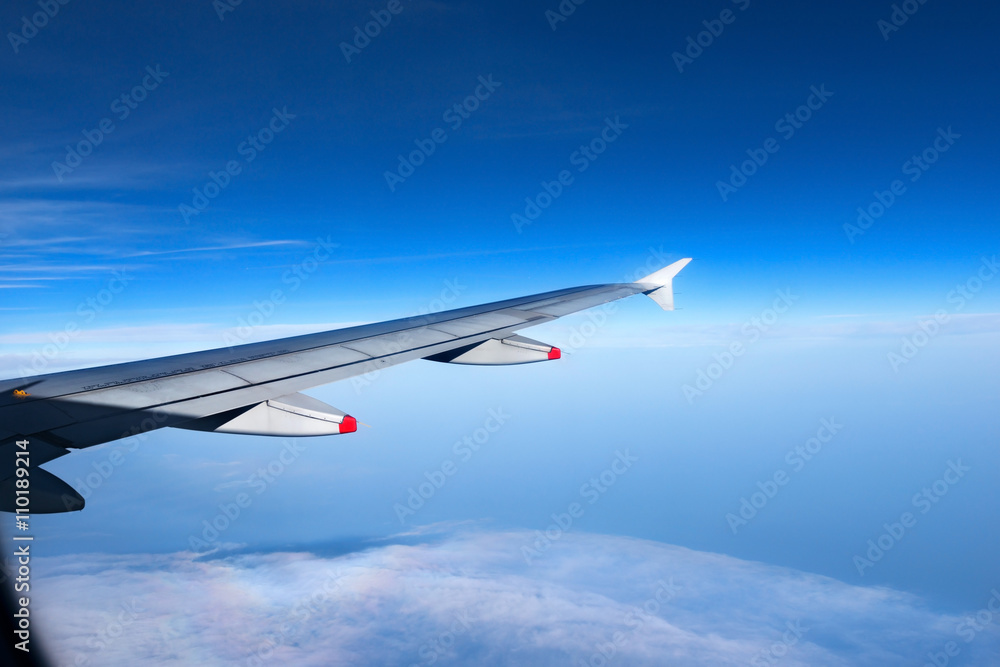 Wing of a Plane with Blue Sky and Clouds Wing of a Plane with Blue Sky and Clouds