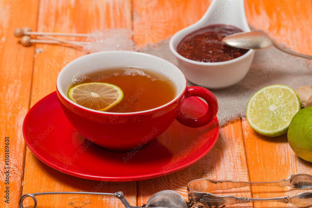 Cup of tea with ginger, raspberry jam and lemon Cup of tea with ginger, raspberry jam and lemon
