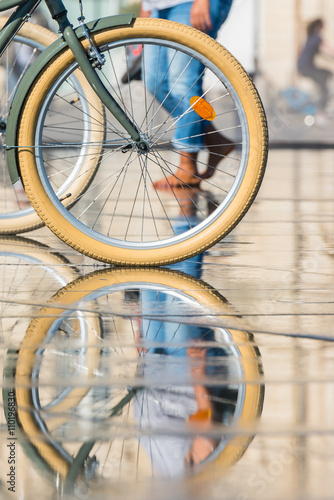 People riding bicycles in the mirror fountain