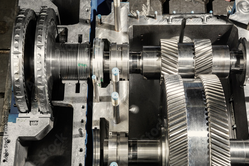 A part of a small steam turbine. Metal gears. Gear wheels of the engine.
