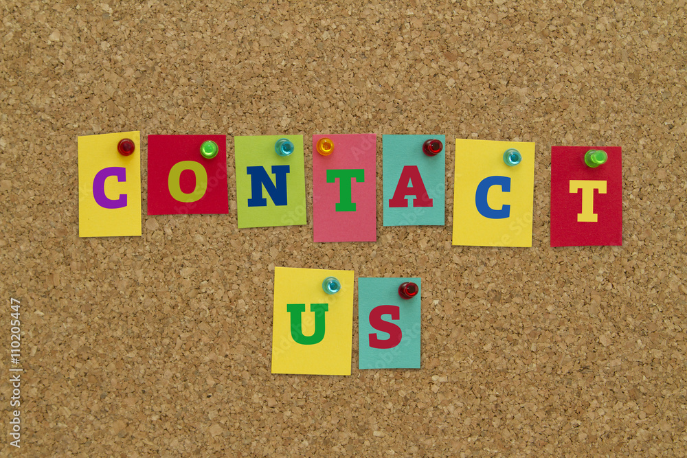 Contact Us written on colorful notes pinned on cork board. Contact Us written on colorful notes pinned on cork board.