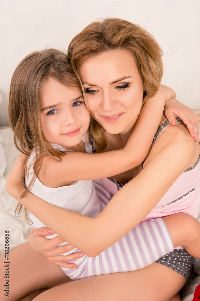 Close up portrait of mother huging her little daughter Close up portrait of mother huging her little daughter