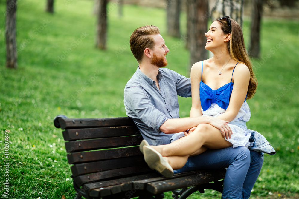 Dating couple sitting on bench Dating couple sitting on bench