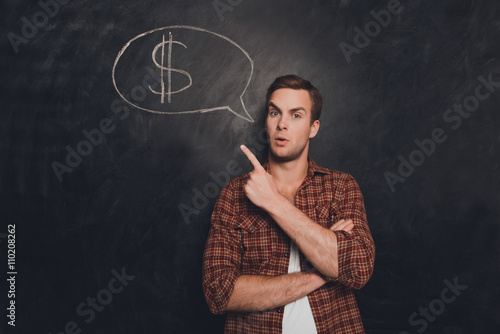 Portrait of minded man pointing on his mind about money