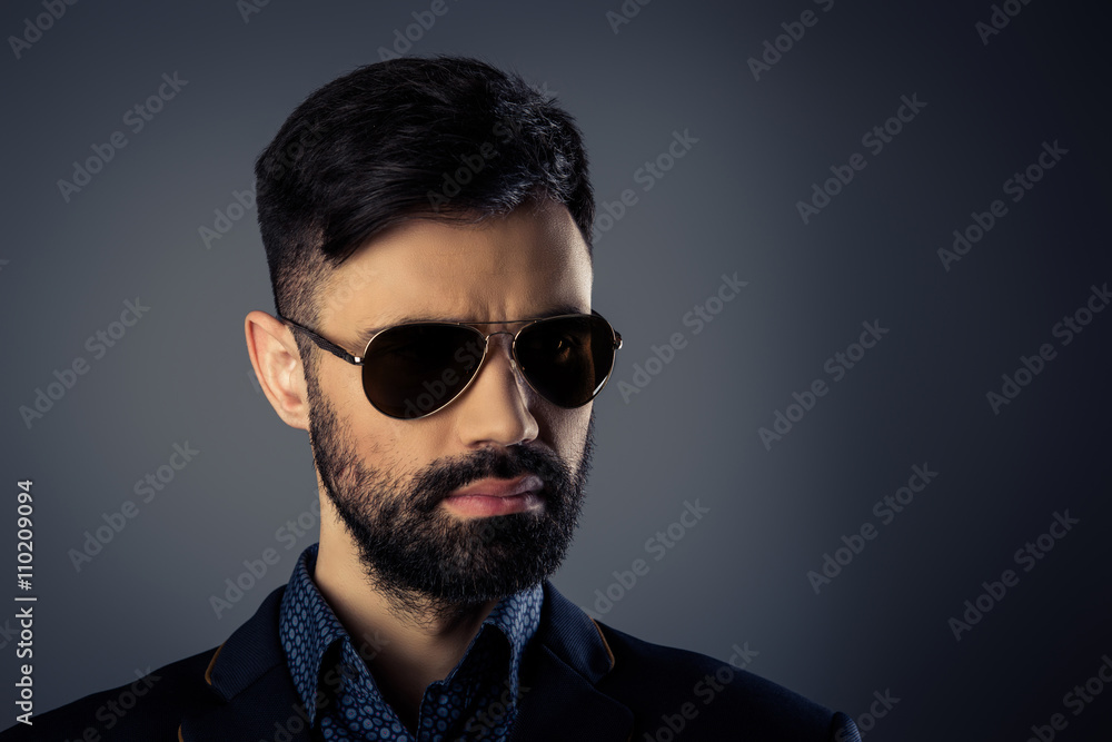 Portrait of brutal handsome man in jacket and spectacles Portrait of brutal handsome man in jacket and spectacles