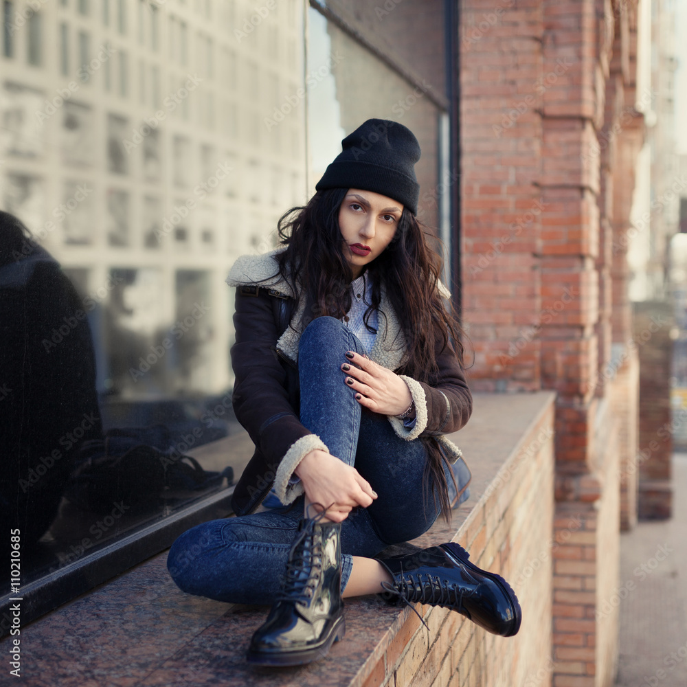 Outdoor lifestyle portrait of pretty young girl, wearing hipster swag grunge  style on urban background. Wearing hat and jeans denim. Spring fashion  woman. Toned style instagram filters. Stock Photo | Adobe Stock