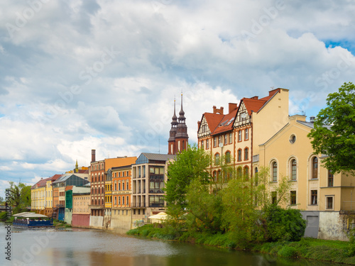 Old, historic buildings along water canal in Opole, Poland, Europe