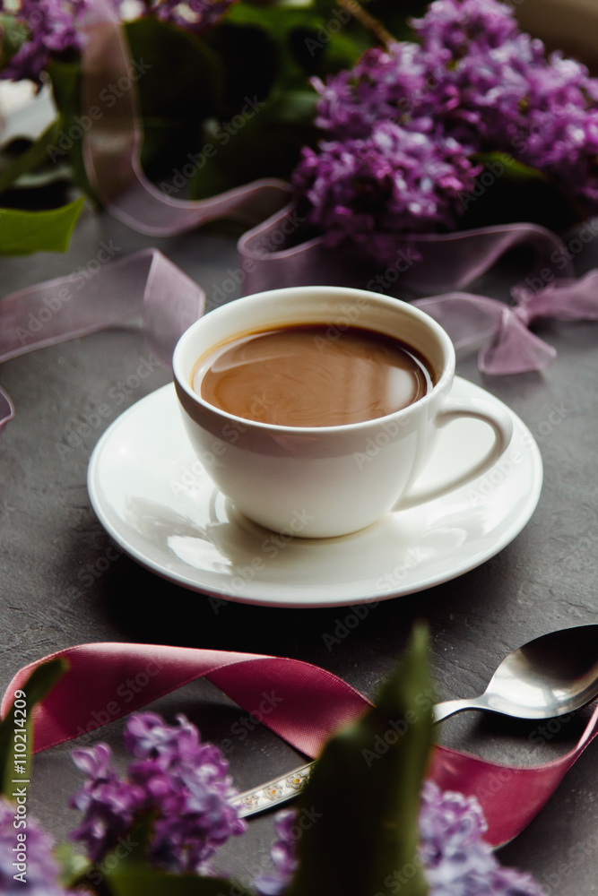 Beautiful background with a Cup of hot coffee with lilacs Beautiful background with a Cup of hot coffee with lilacs