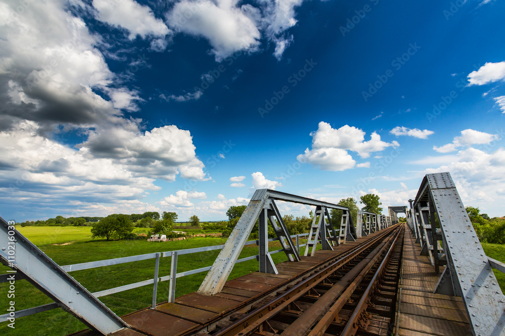 Old railroad bridge profiled on blue sky in summer Old railroad bridge profiled on blue sky in summer