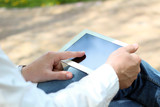 Businessman working with digital tablet outside