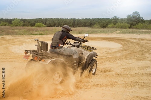 Racing ATV is sand. 