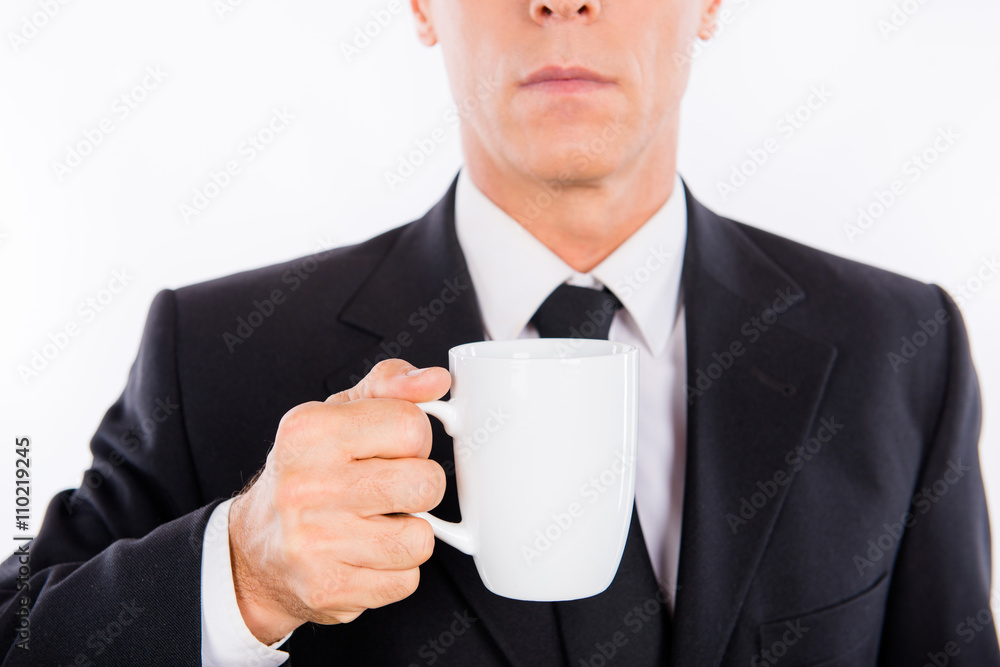 Close up photo of serious businessman holding cup of coffee Close up photo of serious businessman holding cup of coffee