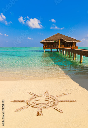 Drawing sun on beach