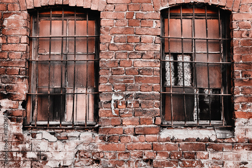 An old abandoned part of the building is a prison. criminal prison cell. dark prison window. prison bars. applied light and color effects.
