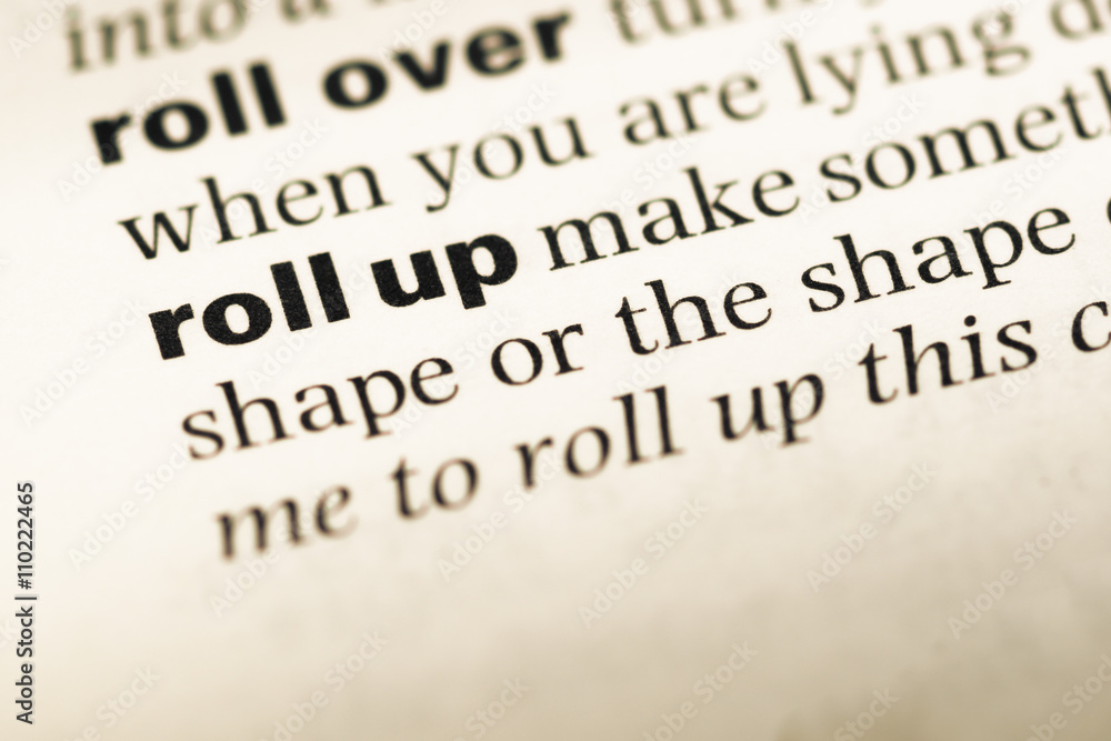 Obraz premium Close up of old English dictionary page with word roll up