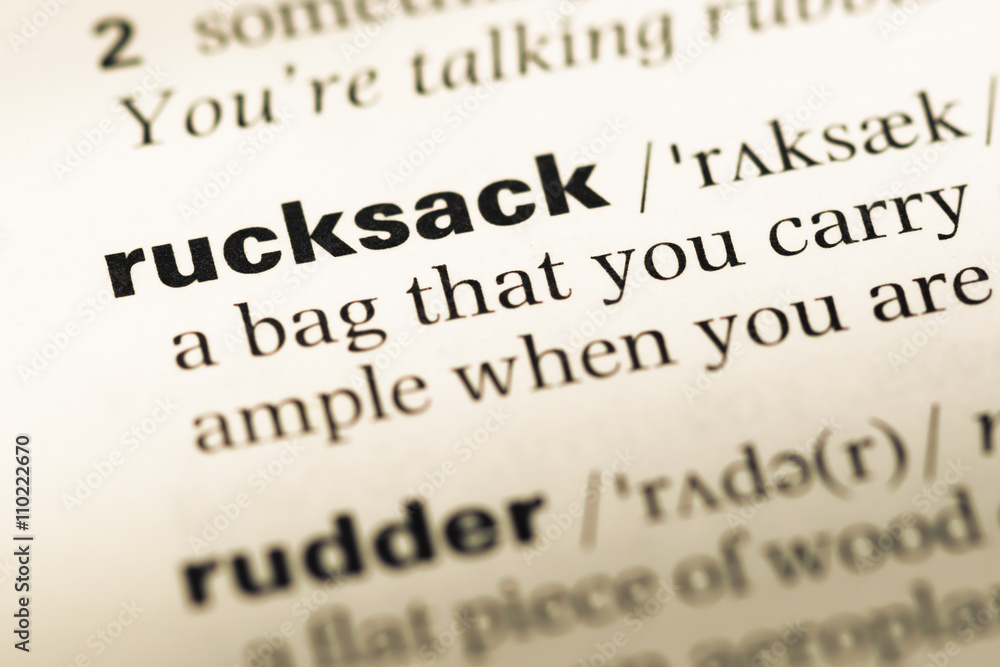 Obraz premium Close up of old English dictionary page with word rucksack
