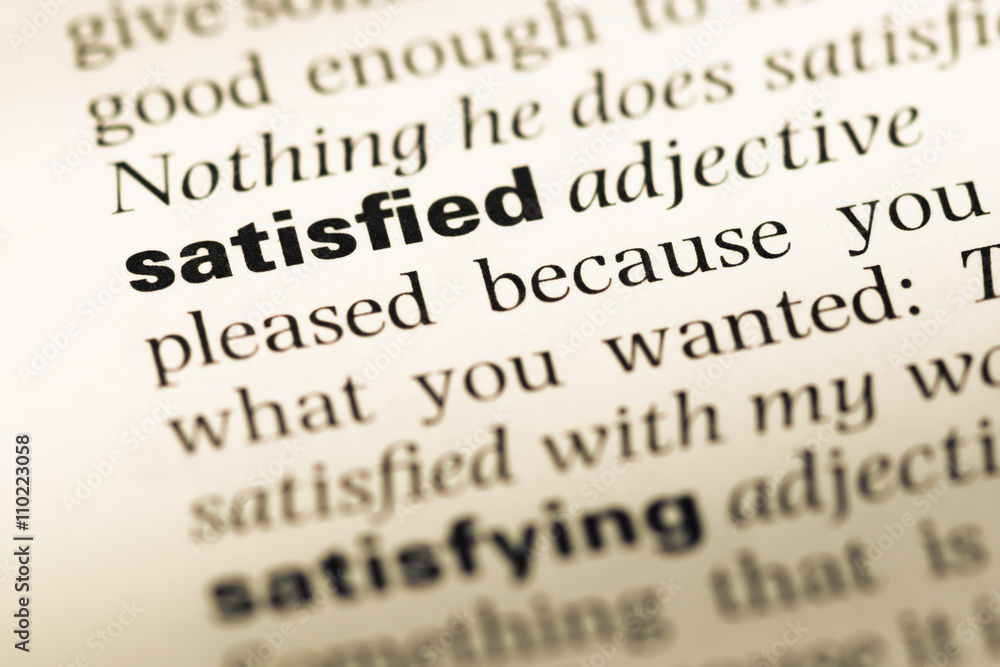 Close up of old English dictionary page with word satisfied Close up of old English dictionary page with word satisfied