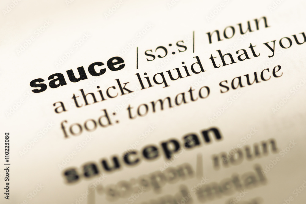 Close up of old English dictionary page with word sauce Close up of old English dictionary page with word sauce