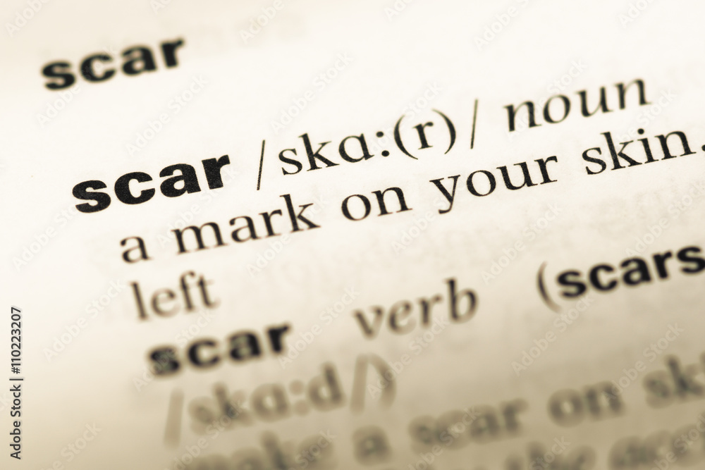 Close up of old English dictionary page with word scar Close up of old English dictionary page with word scar