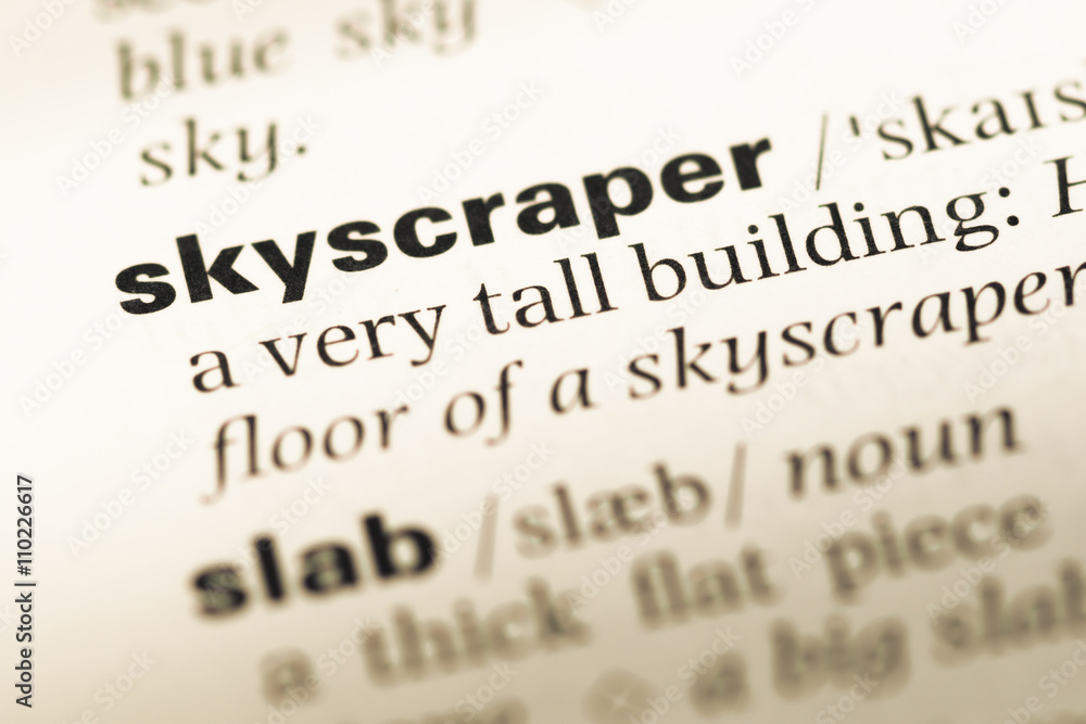 Close up of old English dictionary page with word skyscraper Close up of old English dictionary page with word skyscraper