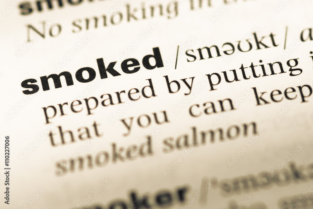 Close up of old English dictionary page with word smoked Close up of old English dictionary page with word smoked