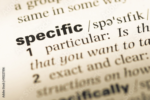 Close up of old English dictionary page with word specific