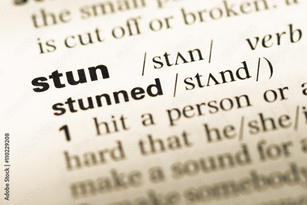 Close up of old English dictionary page with word stun Close up of old English dictionary page with word stun
