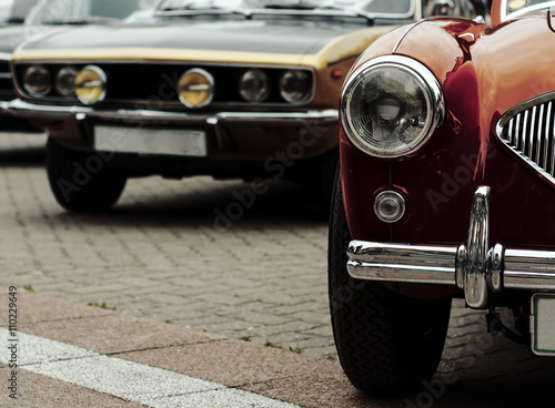 Retro cars parked in old European city street © MarkoVS87