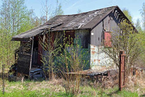 Blue sky. Abandoned house. Abandoned garden plot. rustic house. poor abandoned house.
