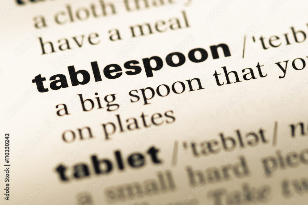 Fototapeta premium Close up of old English dictionary page with word tablespoon