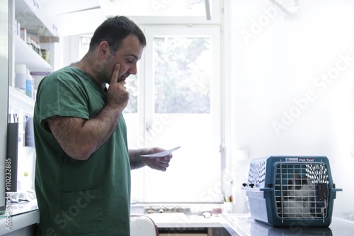 Vet reading a cat's notes