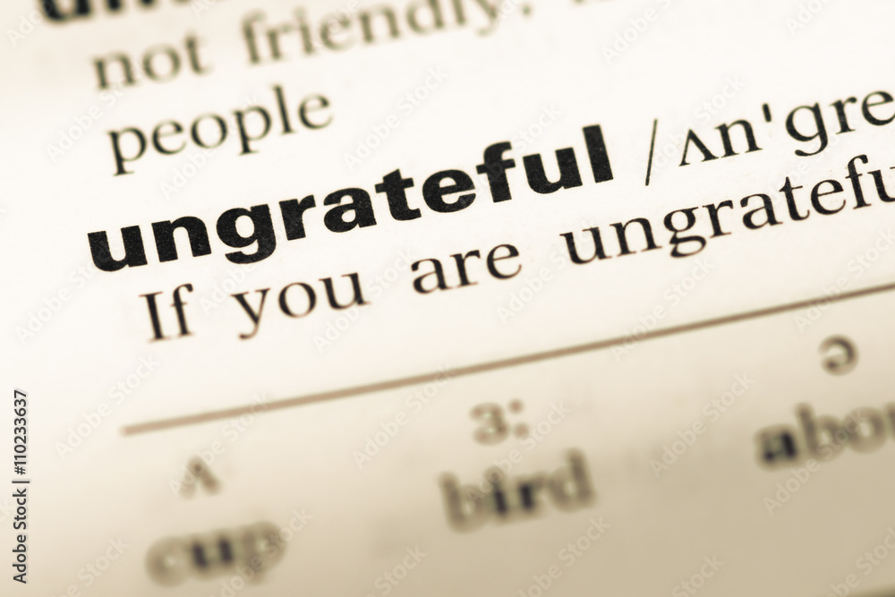 Close up of old English dictionary page with word ungrateful Close up of old English dictionary page with word ungrateful