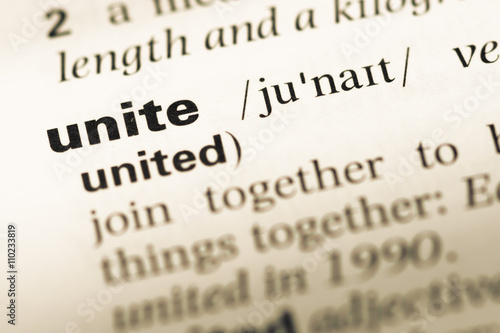 Fotografie Close up of old English dictionary page with word unite