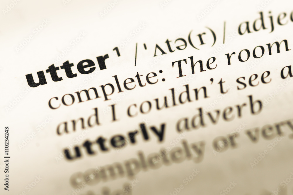 Close up of old English dictionary page with word utter Close up of old English dictionary page with word utter