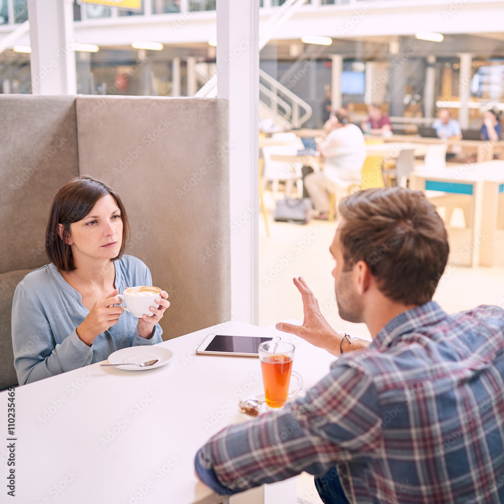 Woman looking very upset towards the man accross from her Woman looking very upset towards the man accross from her