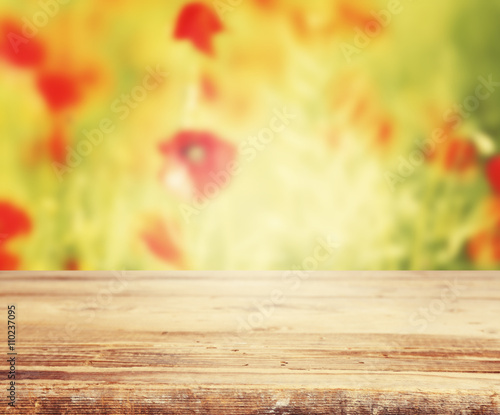 Old wooden board against poppy field