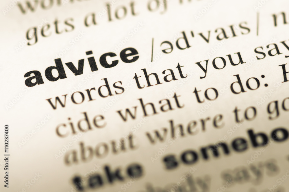 Close up of old English dictionary page with word advice Close up of old English dictionary page with word advice