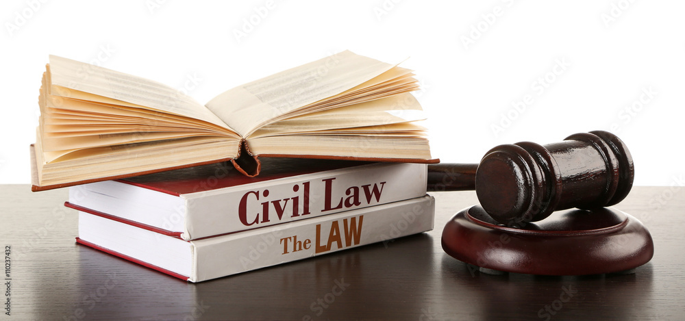 Gavel and books on wooden table on white background