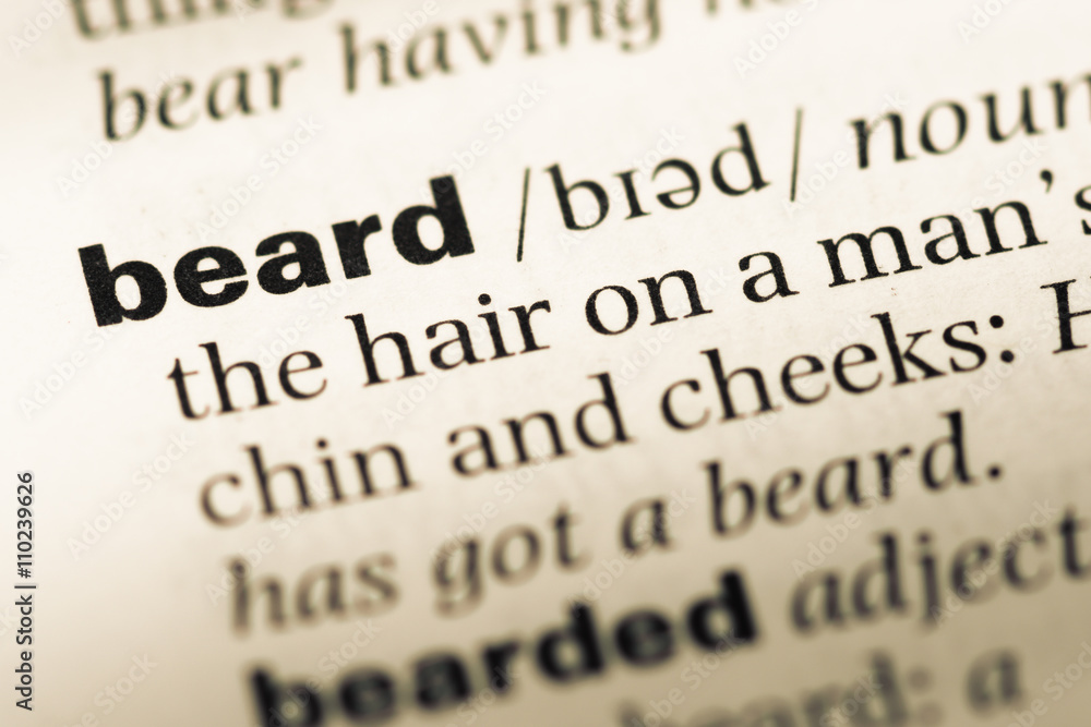 Close up of old English dictionary page with word beard Close up of old English dictionary page with word beard