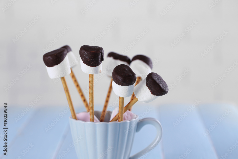 Tasty marshmallows with chocolate on sticks, close up Tasty marshmallows with chocolate on sticks, close up
