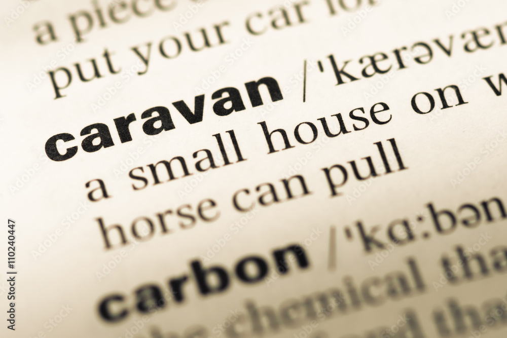 Close up of old English dictionary page with word caravan Close up of old English dictionary page with word caravan