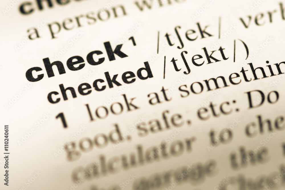 Close up of old English dictionary page with word check Close up of old English dictionary page with word check